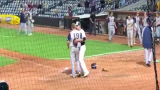 Baseball player hugs childhood friend on the losing team