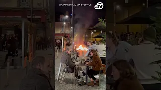 French diners sit with wine despite raging protest fire