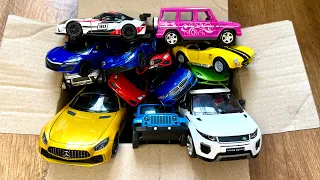Box full of various miniature cars Peugeot, Volvo, Renault, Hyundai, Pagani, Cadillac One, DHL 3