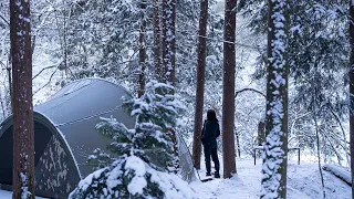 night in the snowy forest. vibe camping in a warm and comfortable shelter. solo camping in the snow