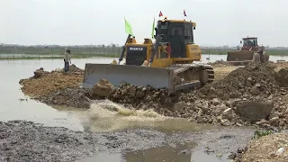 Incredible Dump truck unloading dirt and Dozer wheel loader moving dirt continuing huge lake fill up