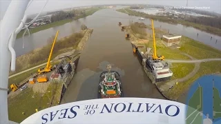 Cruise ship Ovation of the Seas on river: 400m tug boat formation navigating the river Ems