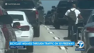 Bicyclist weaves through traffic on 101 Freeway