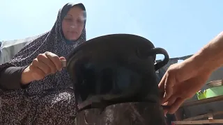 Palestinians displaced by the Israeli offensive live in tents and search for food