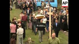 First funerals for siege victims, candles and flowers at scene