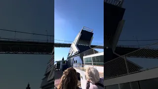 Giant cruise ship is passing through under the bridge, May 10, 2024