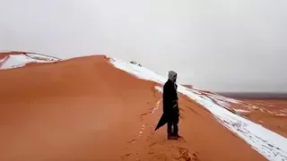 A scene of “Ice and Fire”: Snow blankets Sahara desert