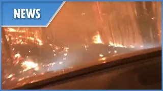 Father and son drive into a wildfire