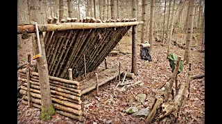 Solo Bushcraft Camp. Natural Shelter, Wool Blanket, Raised Bed, Long Fire.