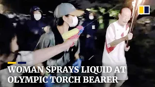 Woman opposing Tokyo Olympics arrested after shooting water pistol at torch bearer