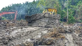 Skill Drive CAT D6D Bulldozer Working to Build Big Dam Foundation in Enclosed Forest