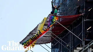 Extinction rebellion protester dressed as Boris Johnson scales Big Ben