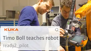 German table tennis star Timo Boll programming a KUKA Robot using KUKA ready2_pilot