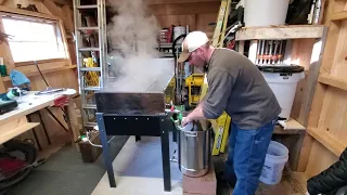 Drawing off and filtering maple syrup.