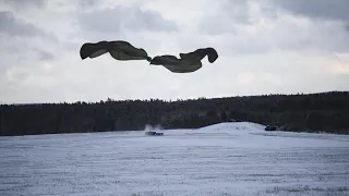 Artillery Paratroopers jump with parachute dropped M777 Howitzer from C-130 Hercules