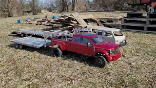 cen f450 red body and VW doka scx10 custom truck both haul a big load of wood on custom goose necks