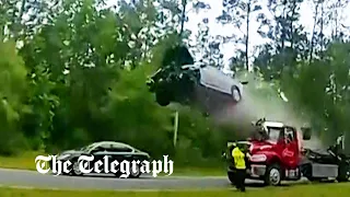 Car flies through the air after hitting tow truck ramp