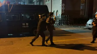 Police lead away protester in Shanghai | AFP