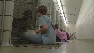 Middle school students read to shelter dogs