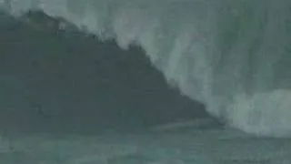 Surfer Surfs a Tsunami ( brave or stupid you decide