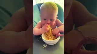Baby eats noodles like a pro