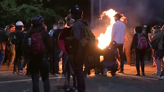 Portland protesters burn pallets during demonstration | AFP