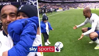 Lucas Moura celebrates with his baby son after scoring a hat-trick against Huddersfield