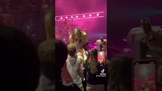 Olivia kisses a fans hand