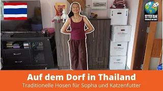 Auf dem Dorf in Thailand. Traditionelle Hosen für Sopha und Katzenfutter