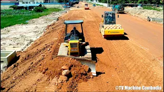 Excellent processing dozer pushing red stone building road with roller skills operator on road