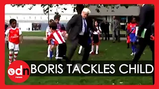 Boris Johnson trips child during football match