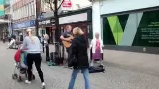 Woman dancing to busker in South shields