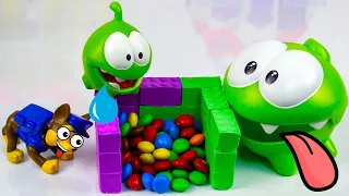 Om Nom and Paw Patrol are built from kinetic sand and candy crumbles!