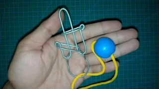 Metal wire and string puzzle solution