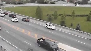 Car escapes traffic by driving backwards, then keeps going