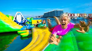 Last To Fall Off WORLDS BIGGEST Inflatable Water Park Obstacle Course!! (Wins $10,000)