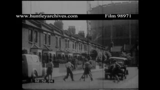 Boys play football in the street.  Archive film 98971