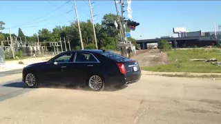 Idiot flies past railroad crossing with an approaching Metra train in Chicago
