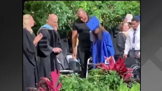 Shooting survivor walks at high school graduation