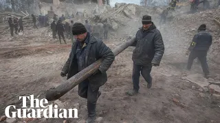 Ukrainian soldiers search through rubble in Okhtyrka after apparent Russian shelling