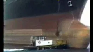 Ship drops anchor on tug boat.