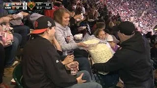 Fan shares big bag of popcorn in the stands