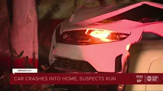 Car crashes into St. Pete home, two people in custody