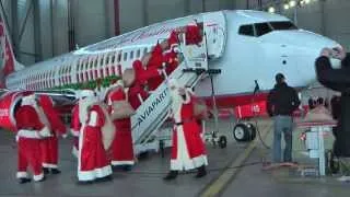 A dozen Santa Claus visiting the Christmas aircraft "Merry Santa" of Air Berlin