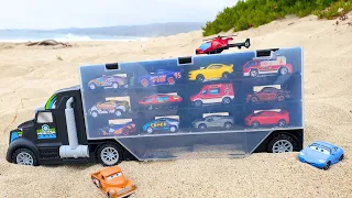 Playing with the truck and cars in the sand.