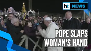 Pope Francis slaps woman's hand to free himself after she roughly pulls him