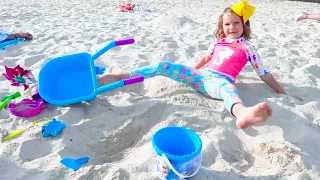 Max and Katy Playing on the Beach with dad