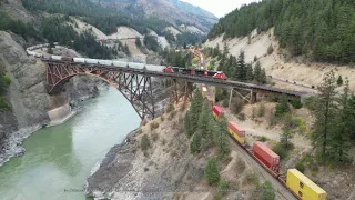 Simultaneous trains crossing the Fraser canyon at scenically stunning Cisco, British Columbia