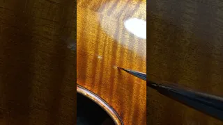 Retouching violin back