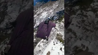 Wingsuit BASE jumping over and landing on a frozen Norwegian fjord.